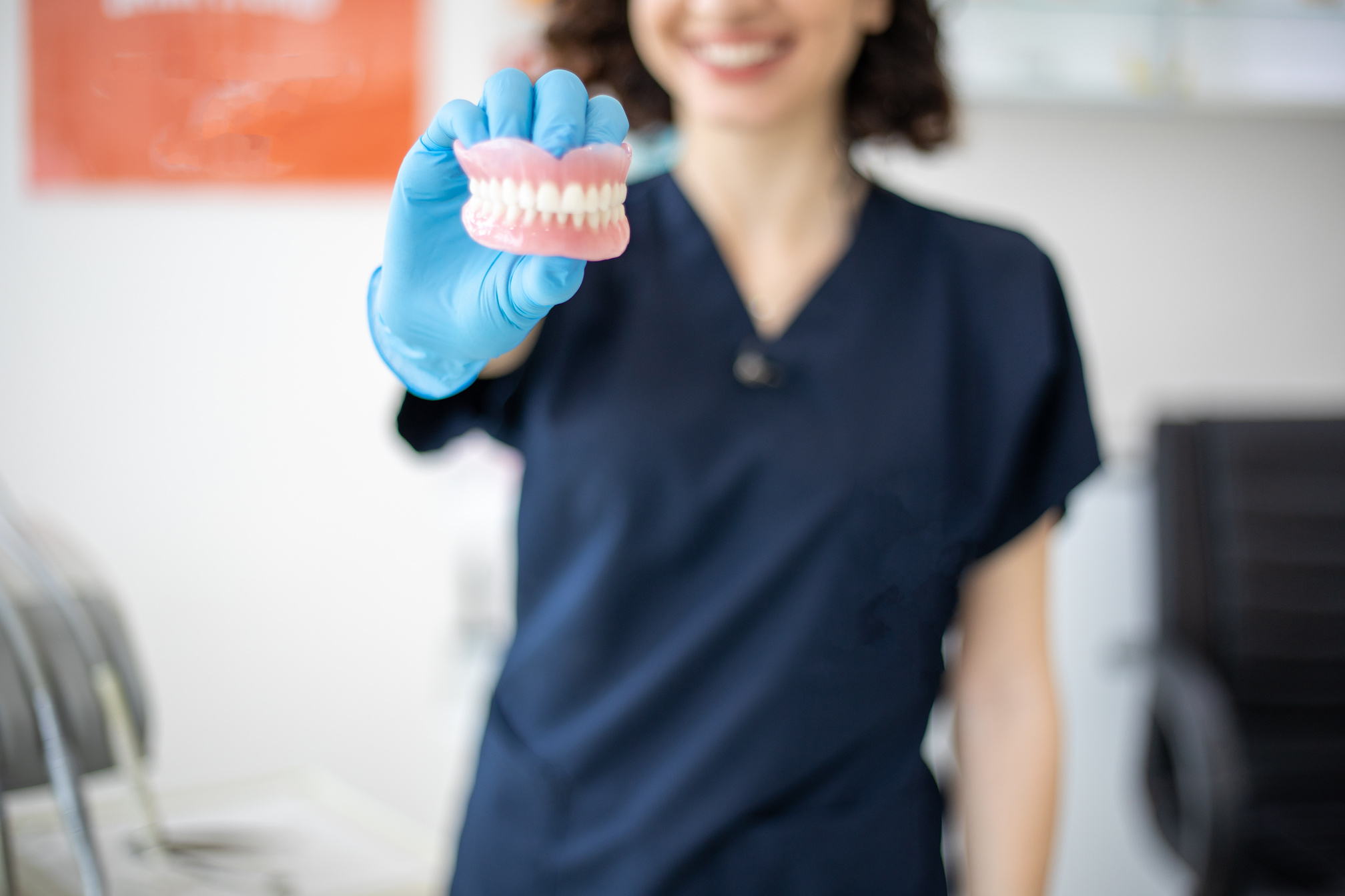 Dentist holding denture